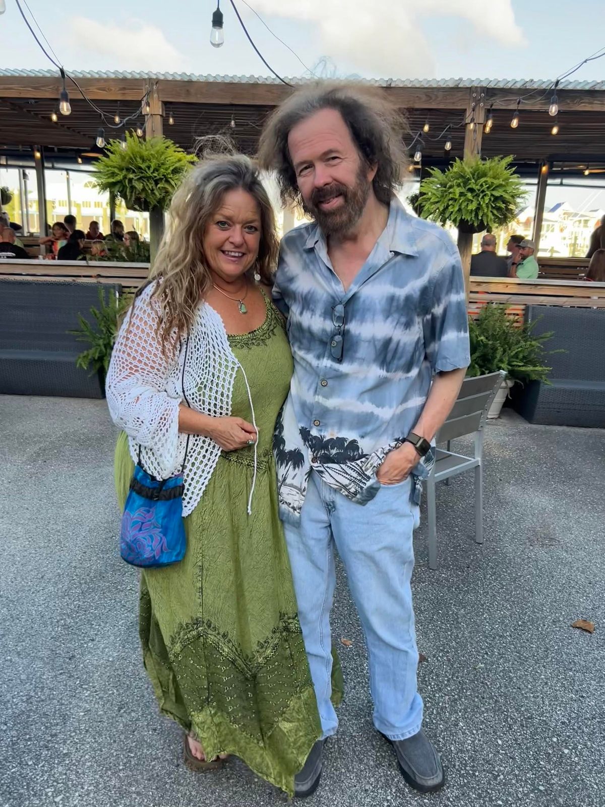 Holly Frost and Rob Otis of Moonglow, on a venue patio under string lights.